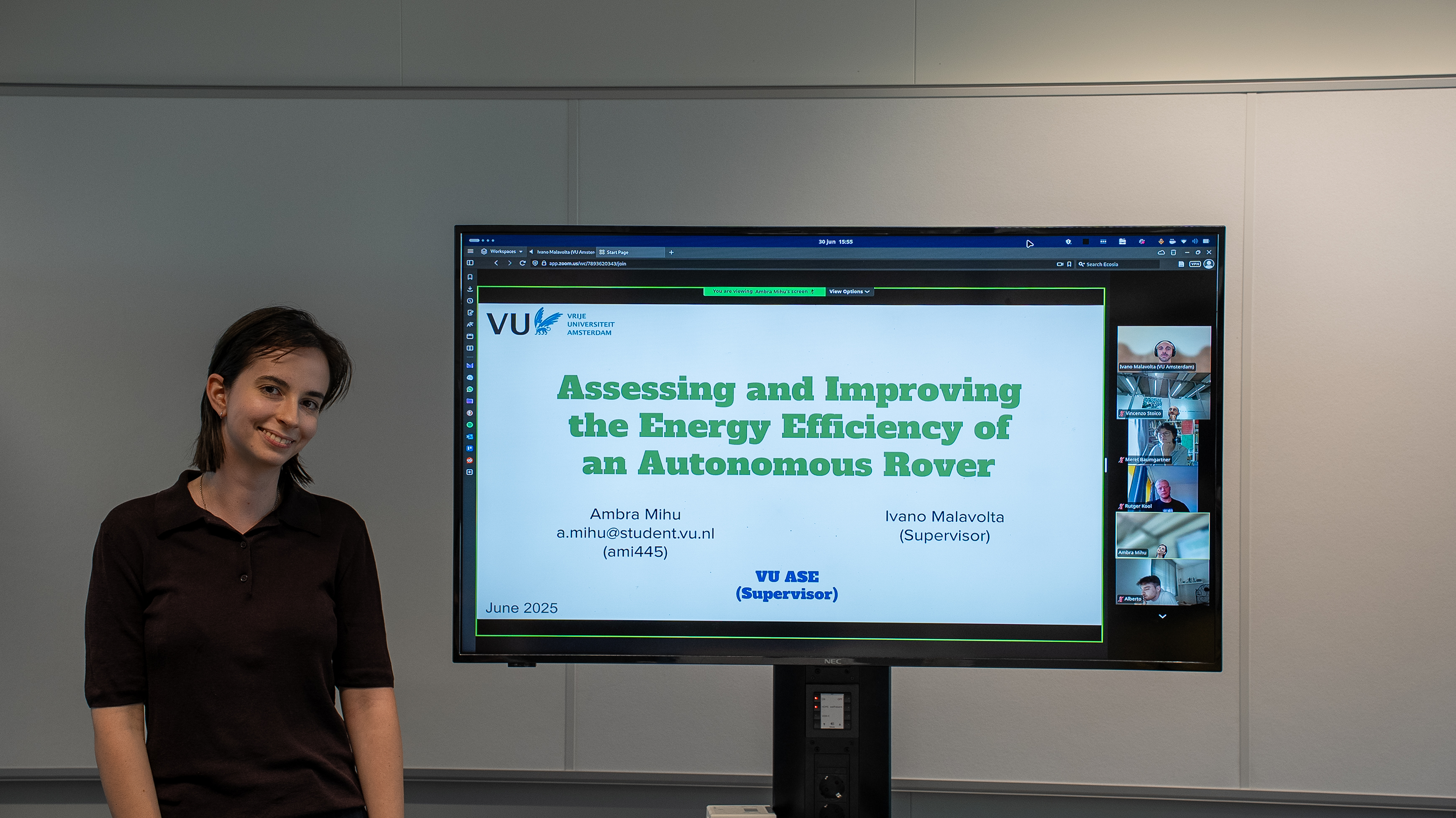 Ambra standing in-front of title slide presentation picture