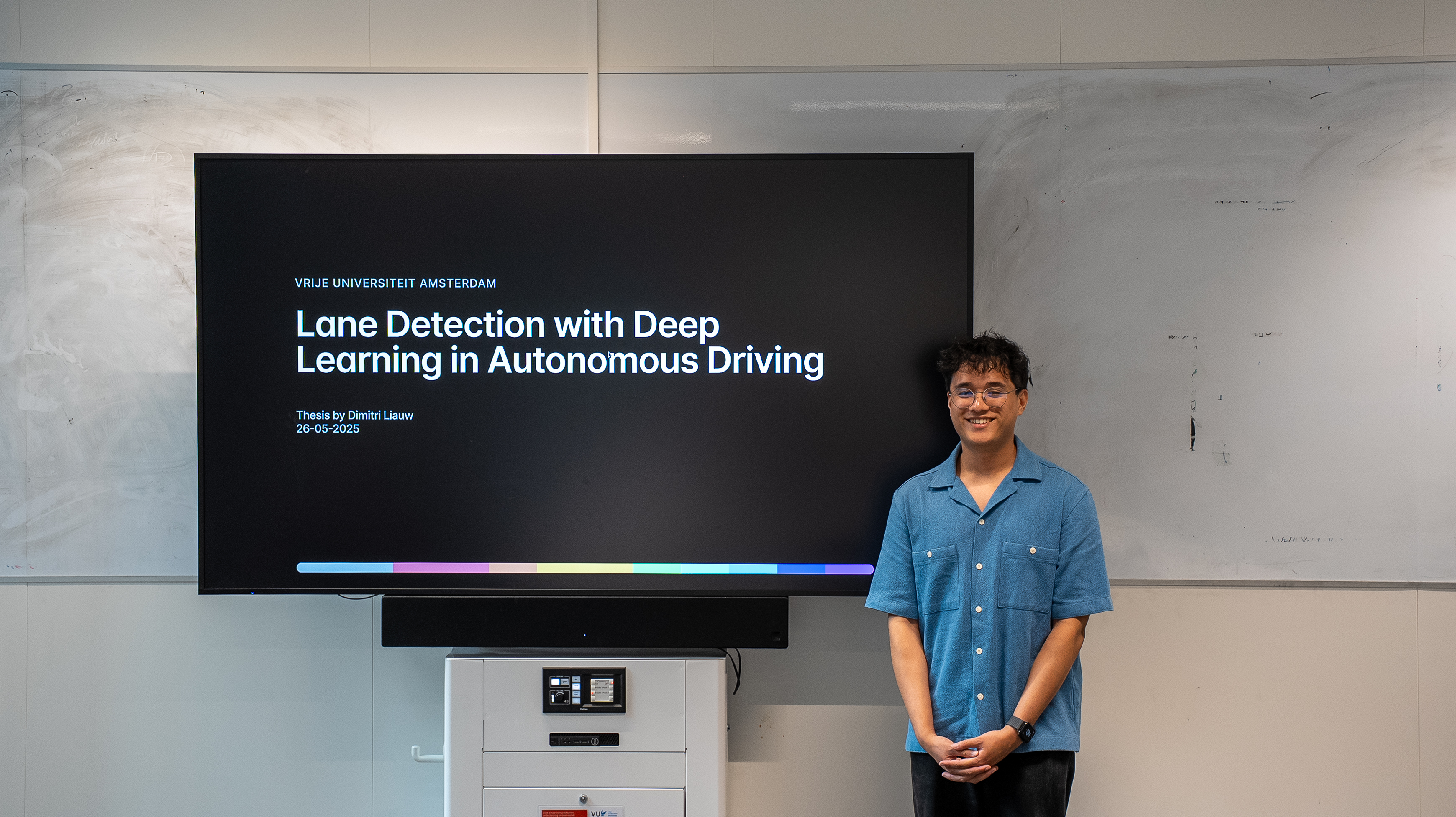 Dimitri standing in-front of title slide presentation picture
