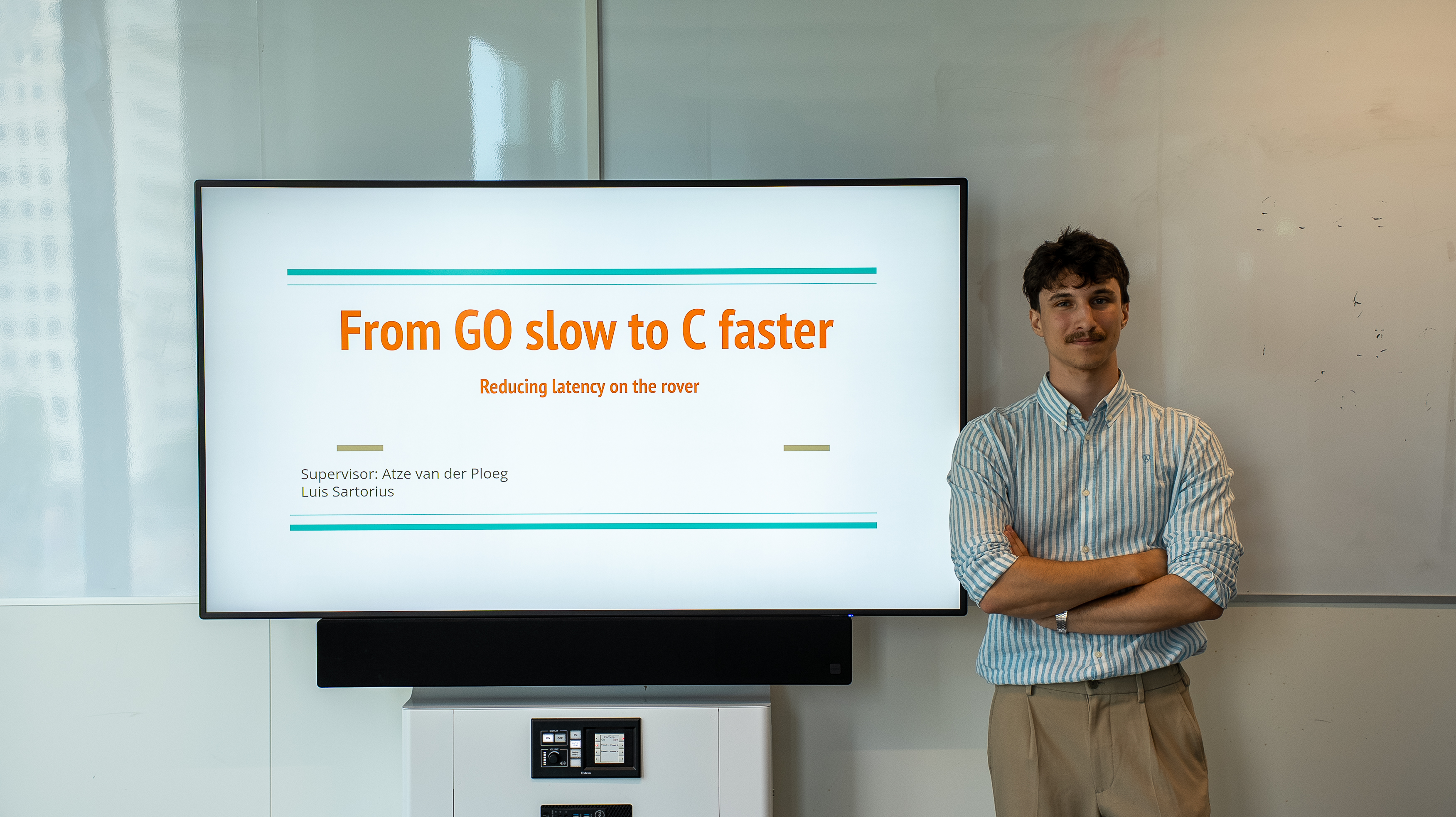 Luis standing in-front of title slide presentation picture