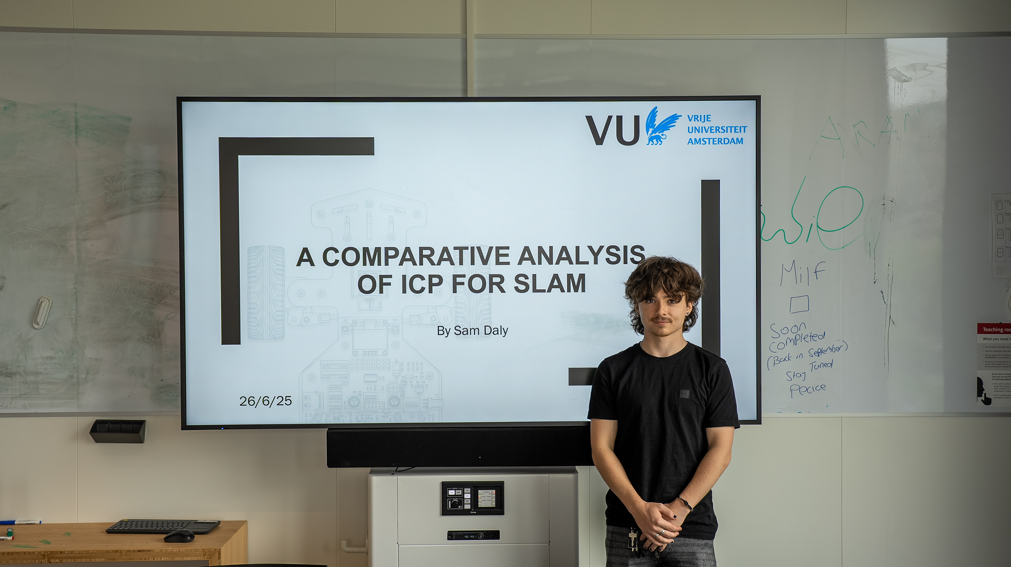 Sam standing in-front of title slide presentation picture